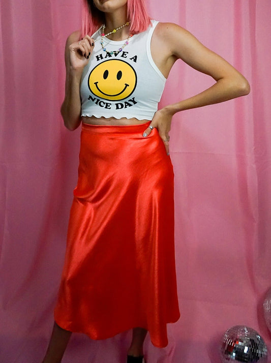 bright red satin midi skirt with smiley face tank top